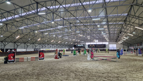 How does arena footing impact show jumping performance and horse welfare?